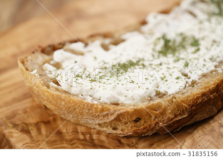 ricotta cheese with herbs on fresh rustic bread ricotta cheese with herbs on fresh rustic bread 31835156