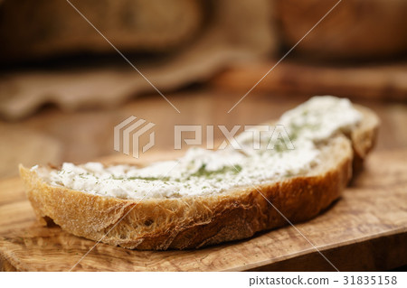 ricotta cheese with herbs on fresh rustic bread 31835158