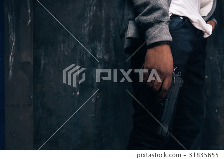 Unrecognizable armed black rapist closeup 31835655