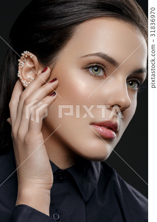 Beautiful girl with pearls on ear 31836970