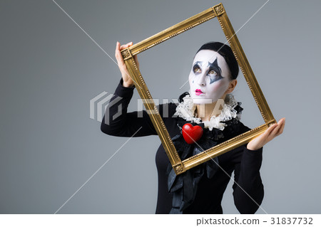 Woman in disguise harlequin in the picture frame Woman in disguise harlequin in the picture frame 31837732