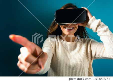 Young woman using virtual reality headset Young woman using virtual reality headset 31839767