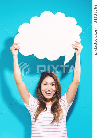 Young woman holding a speech bubble Young woman holding a speech bubble 31839768