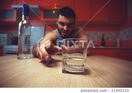 Young drunk man sitting on the table Young drunk man sitting on the table 31840320
