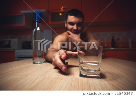 Young caucasian man drinking alcohol at home Young caucasian man drinking alcohol at home 31840347