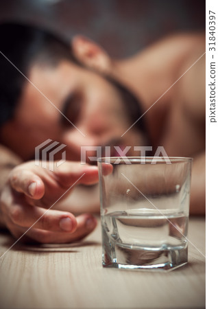 Alcoholic man sleeping at the table 31840397