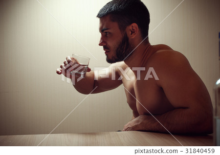 Young caucasian man drinking alcohol at home 31840459