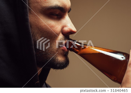 Sad depressed young man drinking beer 31840465