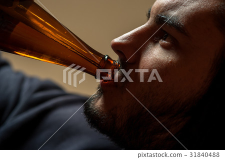 Young man drinking beer, closeup Young man drinking beer, closeup 31840488