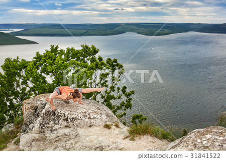 Young woman doing yoga fitness exercises outdoor Young woman doing yoga fitness exercises outdoor 31841522