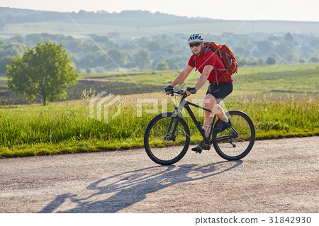 Attractive man in white helmet riding a bike on Attractive man in white helmet riding a bike on 31842930