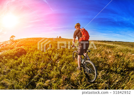 Young cyclist riding mountain bicycle through Young cyclist riding mountain bicycle through 31842932