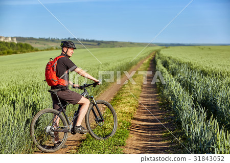 Attractive cyclist standing with mountain bicycle Attractive cyclist standing with mountain bicycle 31843052