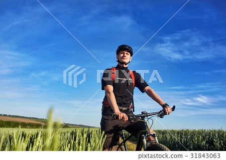 Young cyclist standing with mountain bike on 31843063