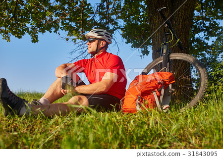 Attractive cyclist in the helmet sitting on the Attractive cyclist in the helmet sitting on the 31843095