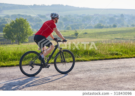 Young attractive cyclist riding mountain bike on Young attractive cyclist riding mountain bike on 31843096