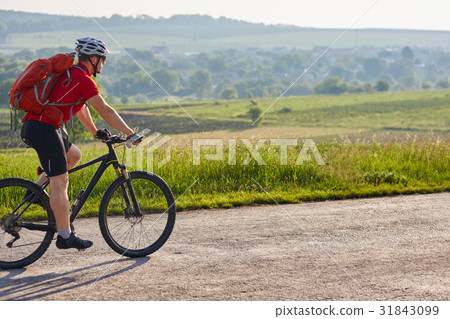 Young attractive cyclist riding mountain bike on Young attractive cyclist riding mountain bike on 31843099