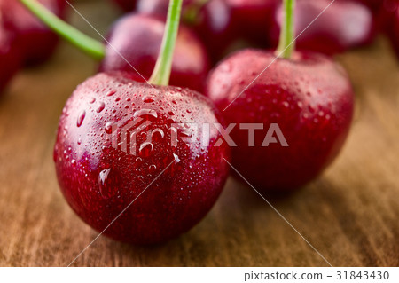 Close up of fresh cherry berries with water drops. 31843430