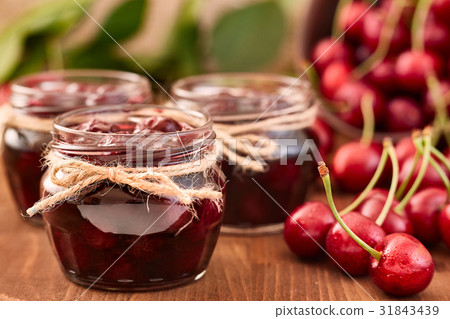 Cherry jam on wooden background in the jars Cherry jam on wooden background in the jars 31843439