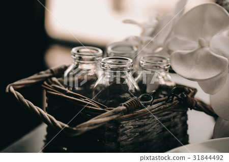 Glass Bottle in vintage Wicker basket. Decor box Glass Bottle in vintage Wicker basket. Decor box 31844492