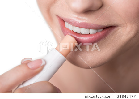 Happy beautiful girl applying decorative cosmetics Happy beautiful girl applying decorative cosmetics 31845477