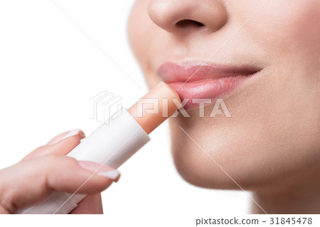 Jolly youthful lady using decorative visage make 31845478