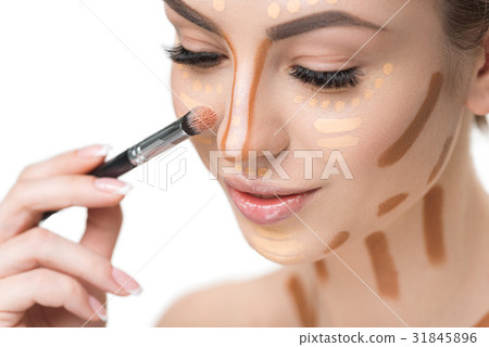 Beautiful young woman doing make-up 31845896