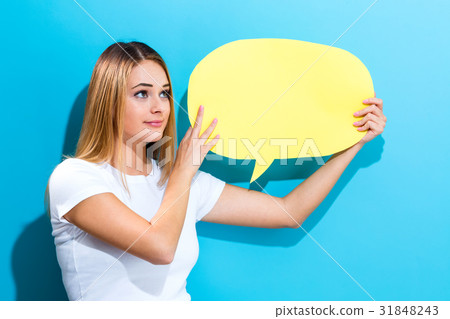 Young woman holding a speech bubble Young woman holding a speech bubble 31848243
