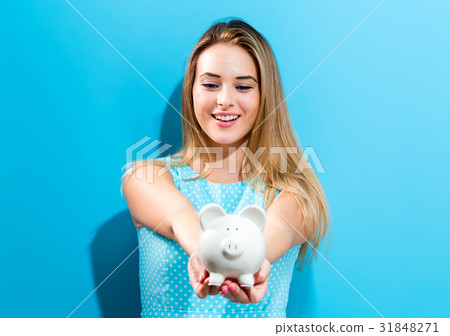 Young woman with a piggy bank 31848271