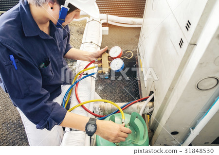 Technician is checking air conditioner 31848530