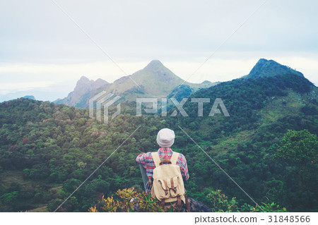 man sitting on mountain,adventure travel concept 31848566