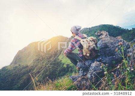 man sitting on mountain,adventure travel concept 31848912