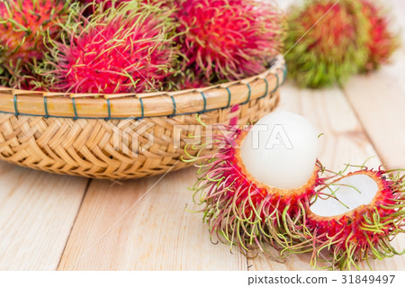 fresh rambutan fruits basket on wood background 31849497
