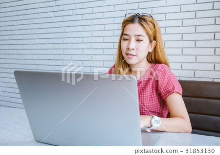 Asian girl working at a coffee shop sitting 31853130