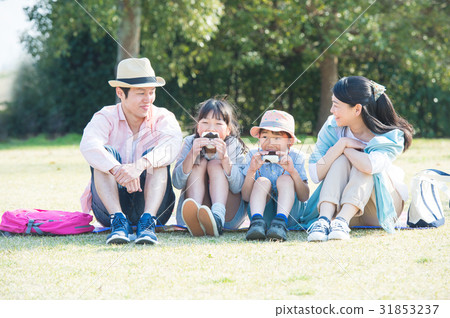 A family at a park picnic A family at a park picnic 31853237