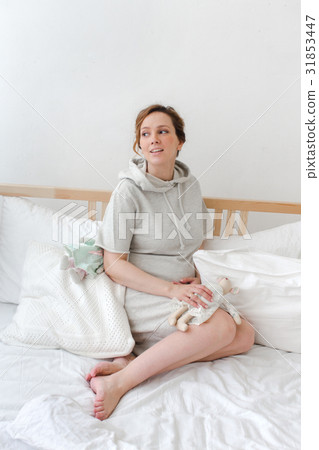 Woman with toy on bed Woman with toy on bed 31853447