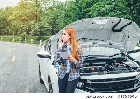 young Woman calling for assistance wit her car young Woman calling for assistance wit her car 31854609