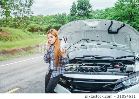 young Woman calling for assistance wit her car young Woman calling for assistance wit her car 31854611