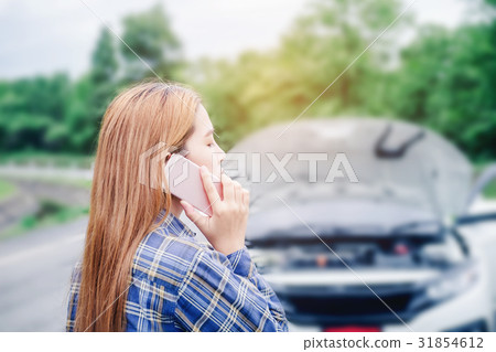 young Woman calling for assistance wit her car young Woman calling for assistance wit her car 31854612