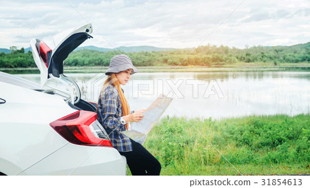 Happy beautiful girl traveling in a hatchback car Happy beautiful girl traveling in a hatchback car 31854613