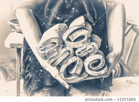 Master potter girl holding many layers cut pieces Master potter girl holding many layers cut pieces 31855869