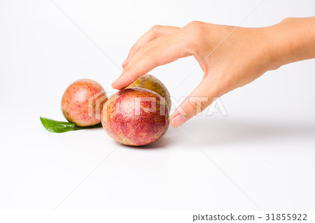 Female hand reaching passion fruit 31855922