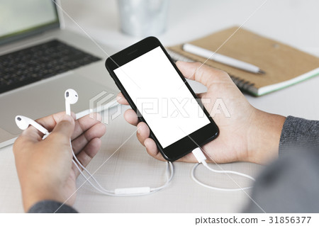 close-up hand holding phone on work desk close-up hand holding phone on work desk 31856377