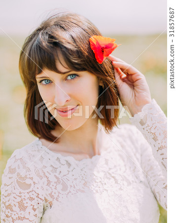The smiling bride with the poppy in the hair. The The smiling bride with the poppy in the hair. The 31857687