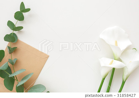 Flowers, eucalyptus and craft envelope on white Flowers, eucalyptus and craft envelope on white 31858427