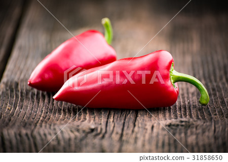 Fresh red pepper on a wooden table 31858650