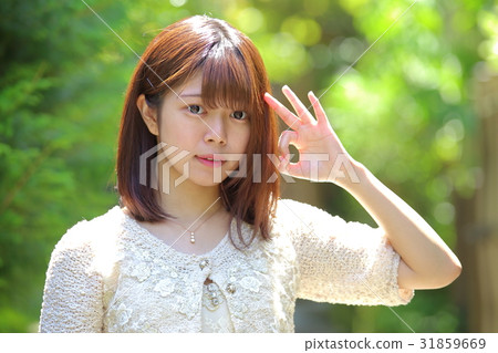 Women's early summer giving an okay sign 31859669