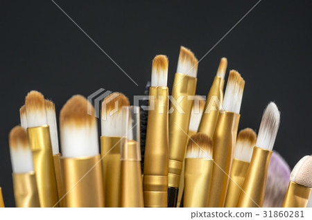 Brush dipping in eye liner 31860281