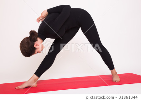 Beautiful athletic girl in black suit doing yoga Beautiful athletic girl in black suit doing yoga 31861344