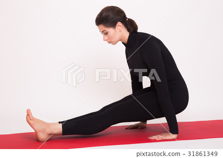 Beautiful athletic girl in black suit doing yoga Beautiful athletic girl in black suit doing yoga 31861349